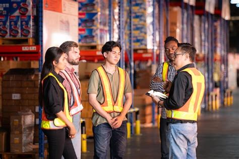 A group of warehouse employees inspecting products on warehouse shelves ...