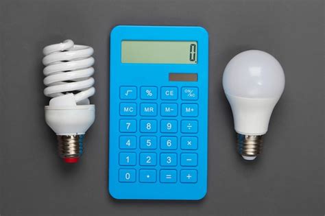 Energy saving. calculator with light bulbs on gray | Premium Photo