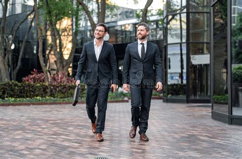 Two Business People Walking Side by Side 的图像结果