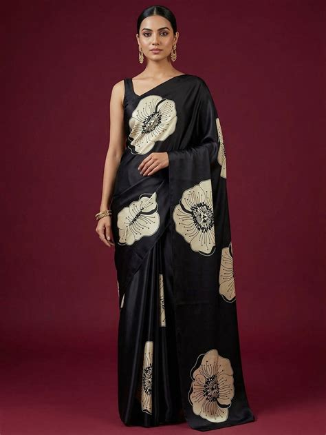 Timeless elegance in this black satin saree adorned with delicate flor