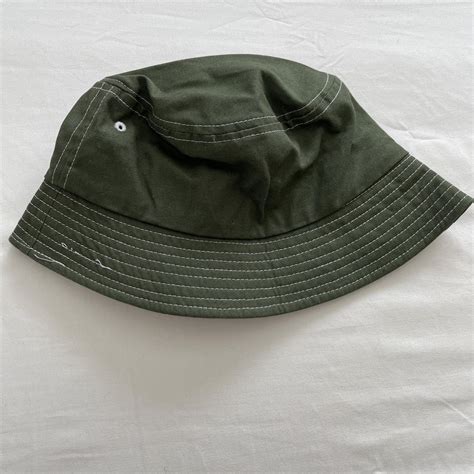 - dark green bucket hat - slight flaw on stitching -... - Depop