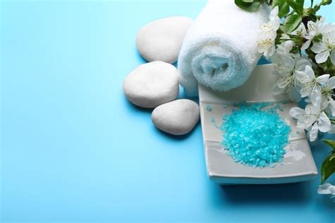 Spa treatment with blooming branch on blue background | Premium Photo