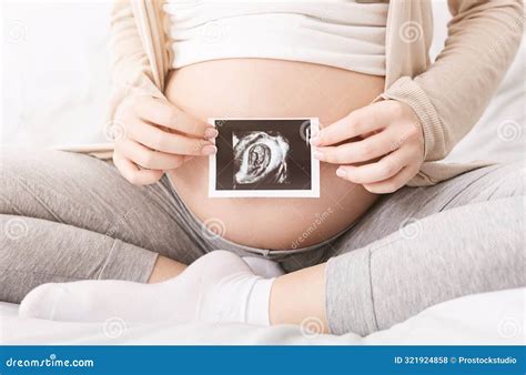 Pregnant Woman Holding Ultrasound Photo Near Belly Stock Photo - Image ...