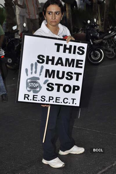 A protester holds a placard urging people to stop discrimination ...