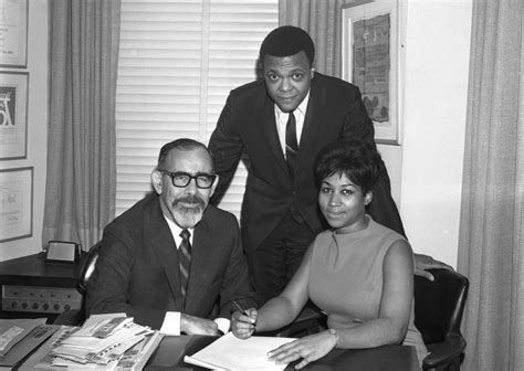 Aretha Franklin signs her contract with Atlantic Records alongside ...