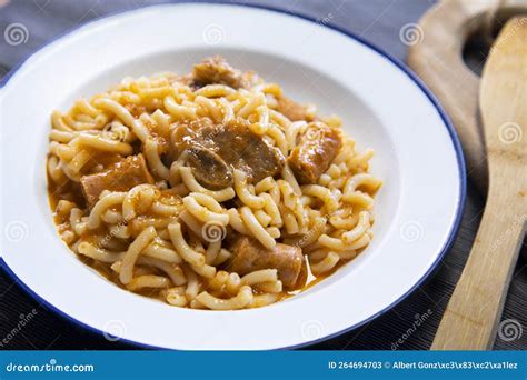 Fideua with Pork. Casserole Noodles with Pork and Sausages. Traditional ...