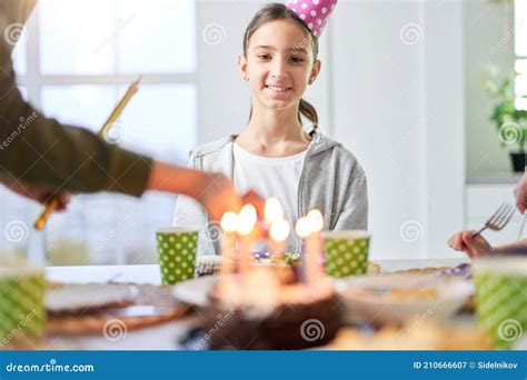 Happy Teenage Latin Girl in Birtday Cap Smiling and Looking at Birthday ...