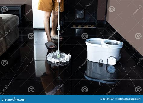 Man Mopping Floor and Mopping Bucket on the Floor Stock Image - Image ...
