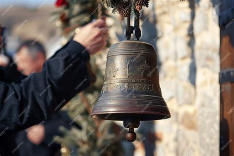 Image shows bell about three metres high, with celebrant alongside