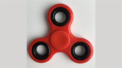 Download Unwind Your Thoughts with Red Fidget Toy Wallpaper | Wallpapers.com