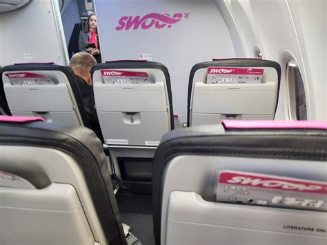 Download White And Pink Seats Of Swoop Aircraft Wallpaper | Wallpapers.com