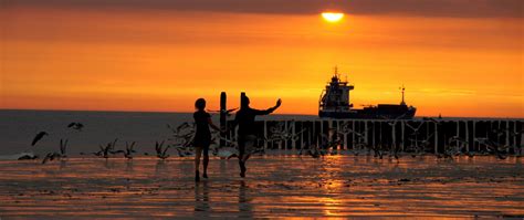 Download wallpaper 2560x1080 beach, promenade, bridge, sea, sunset ...