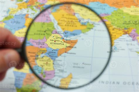 Exploring Ethiopia on a colorful world map with a magnifying glass highlighting its location in ...