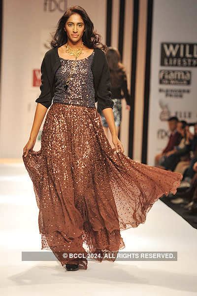 A model walks the ramp to showcase a creation by designer Meera Ali on ...
