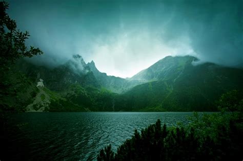 Fog and dark clouds in mountains. | Free Photo
