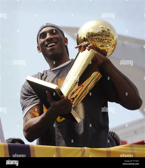 Kobe Bryant holds the championship trophy as the 2009 NBA Champion ...