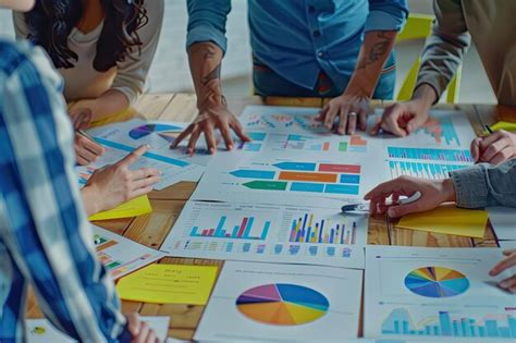 Closeup view of a group working with diagrams and sales charts ...