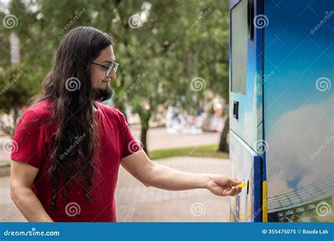 Young Hispanic Man Using Bottle Deposit Point. Man Recycling Plastic ...