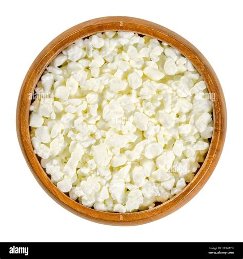 Cottage cheese curd grains in wooden bowl. Igredient to make a fresh ...