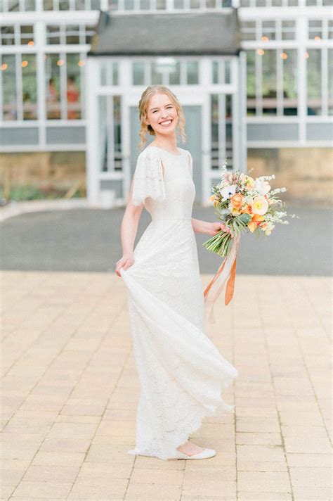 Carenza | Real bride in Dahlia lace & silk wedding gown: flutter sleeves, full skirt & deep V ...