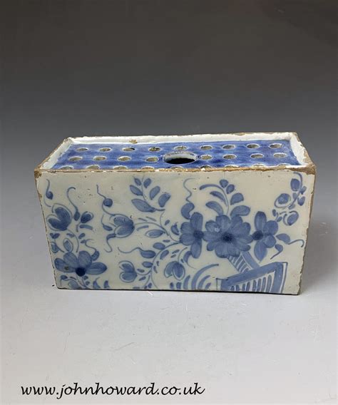 English delftware pottery flower brick painted with blue styled flowers ...