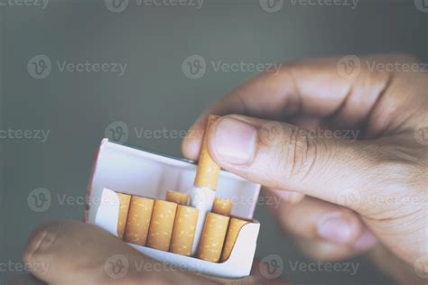 close up man hand holding peel it off cigarette pack prepare smoking a ...