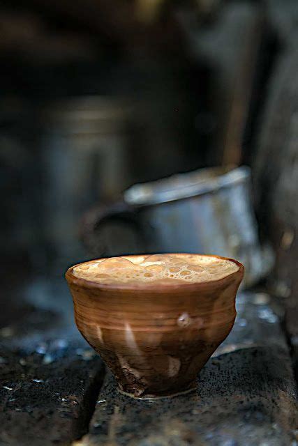 a brown bowl sitting on top of a wooden table