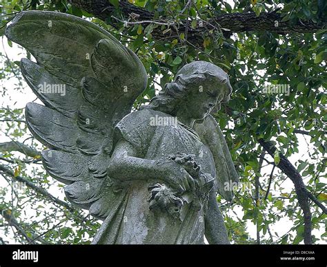 This image shows the angel statues located in Metairie Cemetery, New ...