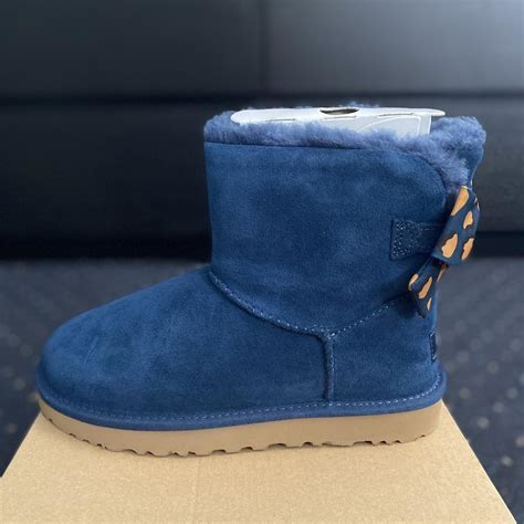 Size 6 womens blue UGG boots with bow - never worn... - Depop