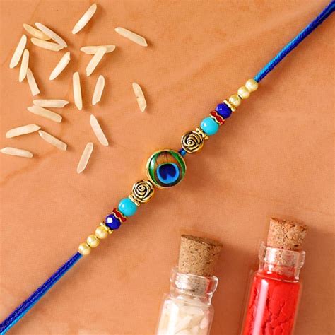 Send Circular Peacock Feather Rakhi Online | Rakhibazaar.com