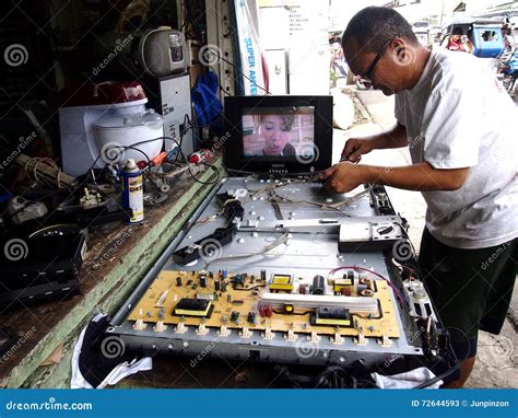 An Electronics Repair Shop Technician Works on a Flat Screen Tv ...