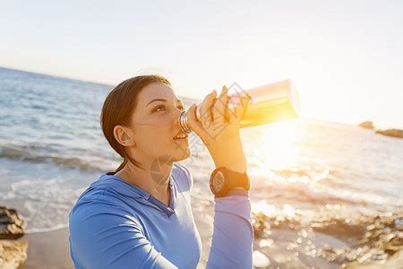 女人海滩上喝水轻女子海滩上锻炼后喝水高清图片下载-正版图片300354836-摄图网