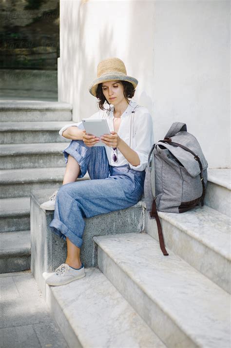 "Woman With Pad Sitting On Stairs" by Stocksy Contributor "Duet Postscriptum" - Stocksy