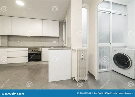 Kitchen Furnished with White Furniture without Handles, Washing Machine ...