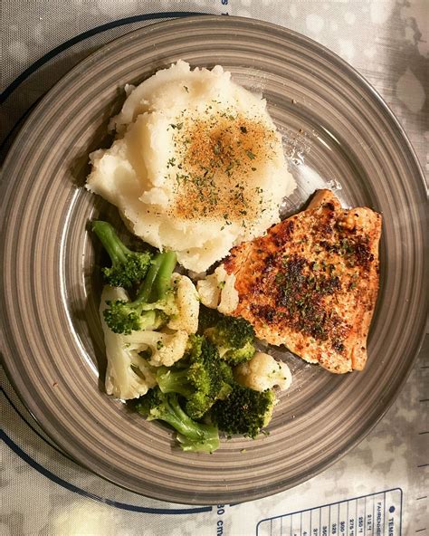 Cast iron Cajun salmon fillet with homemade Cajun seasoned smashed potatoes, broccoli and ...
