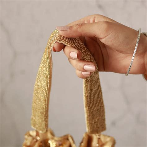 THE TAN CLAN Twinkle Heavy Tassles Potli with Handle - Gold