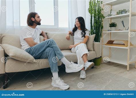 Man and Woman Friends Sitting on the Couch and Smiling Merrily Talking ...