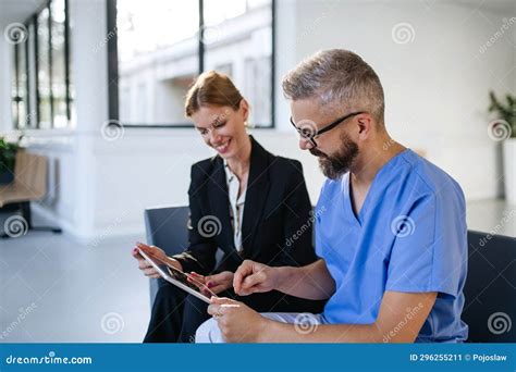 Pharmaceutical Sales Representative Talking with Doctor in Medical Building. Ambitious Female ...