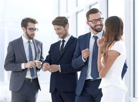 Employees of the company standing in the office lobby | Premium Photo