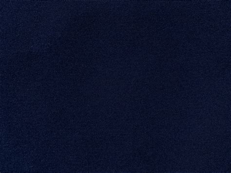 Dark blue velvet fabric texture used as background. Empty dark blue ...