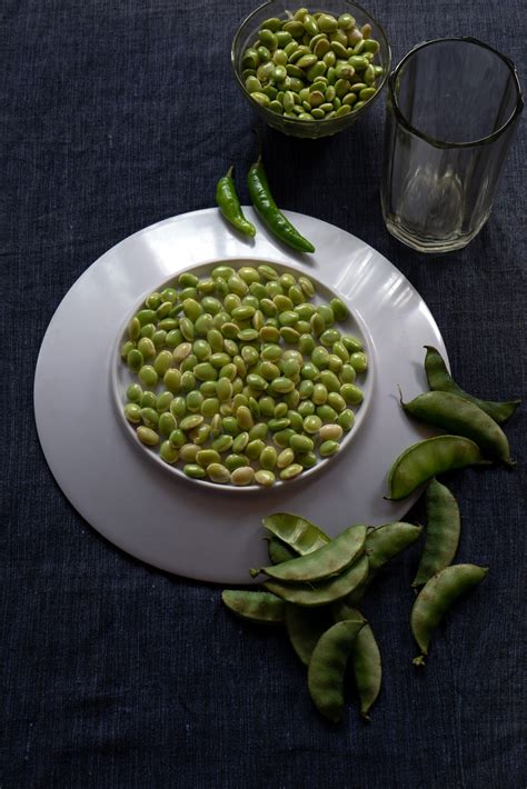 Fresh lima beans stacked together on a white plate - PixaHive