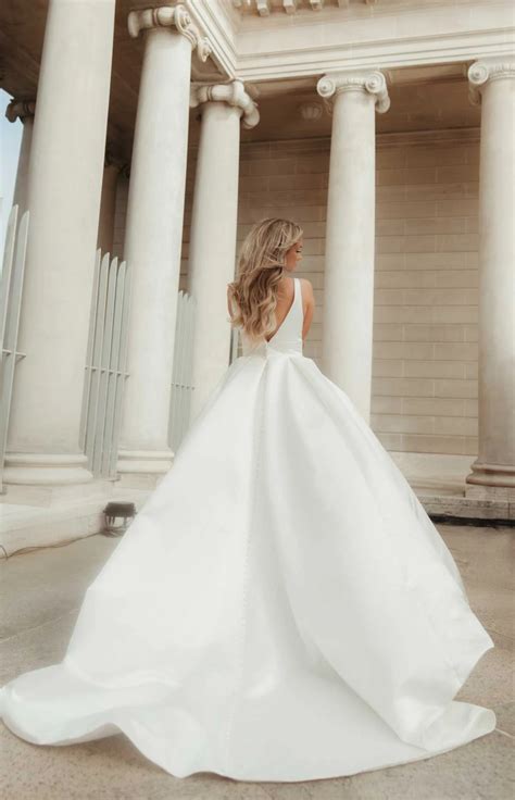 7755 | Stella York | Modern Luxe Ballgown Wedding Dress with Deep V-Neckline | Essense Designs