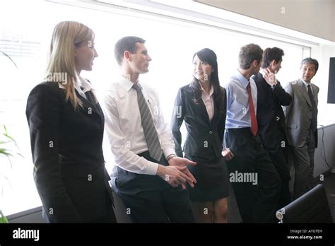 Group of People Standing in a Room Talking 的图像结果