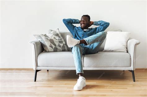 Premium Photo | Happy Black Guy Sitting On Sofa Relaxing At Home