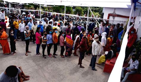 Peoples ignoring social distance stand in a queue to register their ...