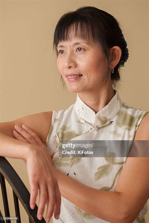 Mature Chinese Woman In Traditional Dress Qipao High-Res Stock Photo ...