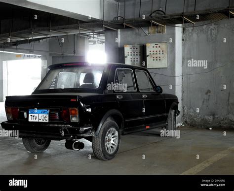 Cairo, Egypt, May 13 2023: an old vintage retro FIAT 128 NASR black car in a garage with new ...