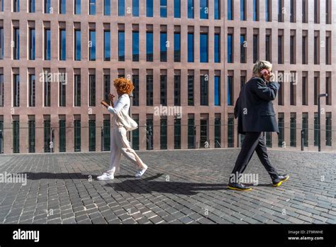 Two Business People Walking Side by Side 的图像结果