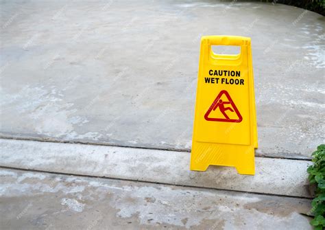 Premium Photo | Yellow caution slippery wet floor sign with slippery ...