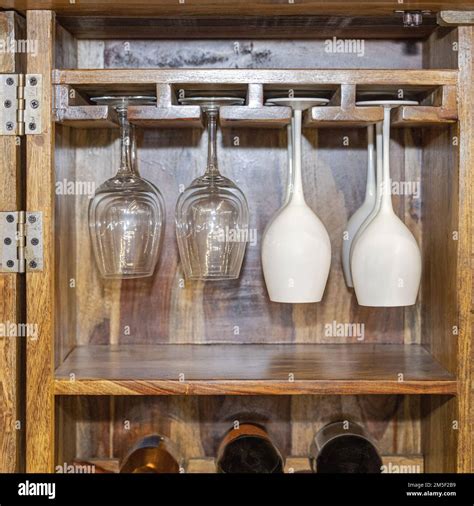 Tall Stemware Glasses Hanging Upside Down in Wooden Cabinet Storage ...